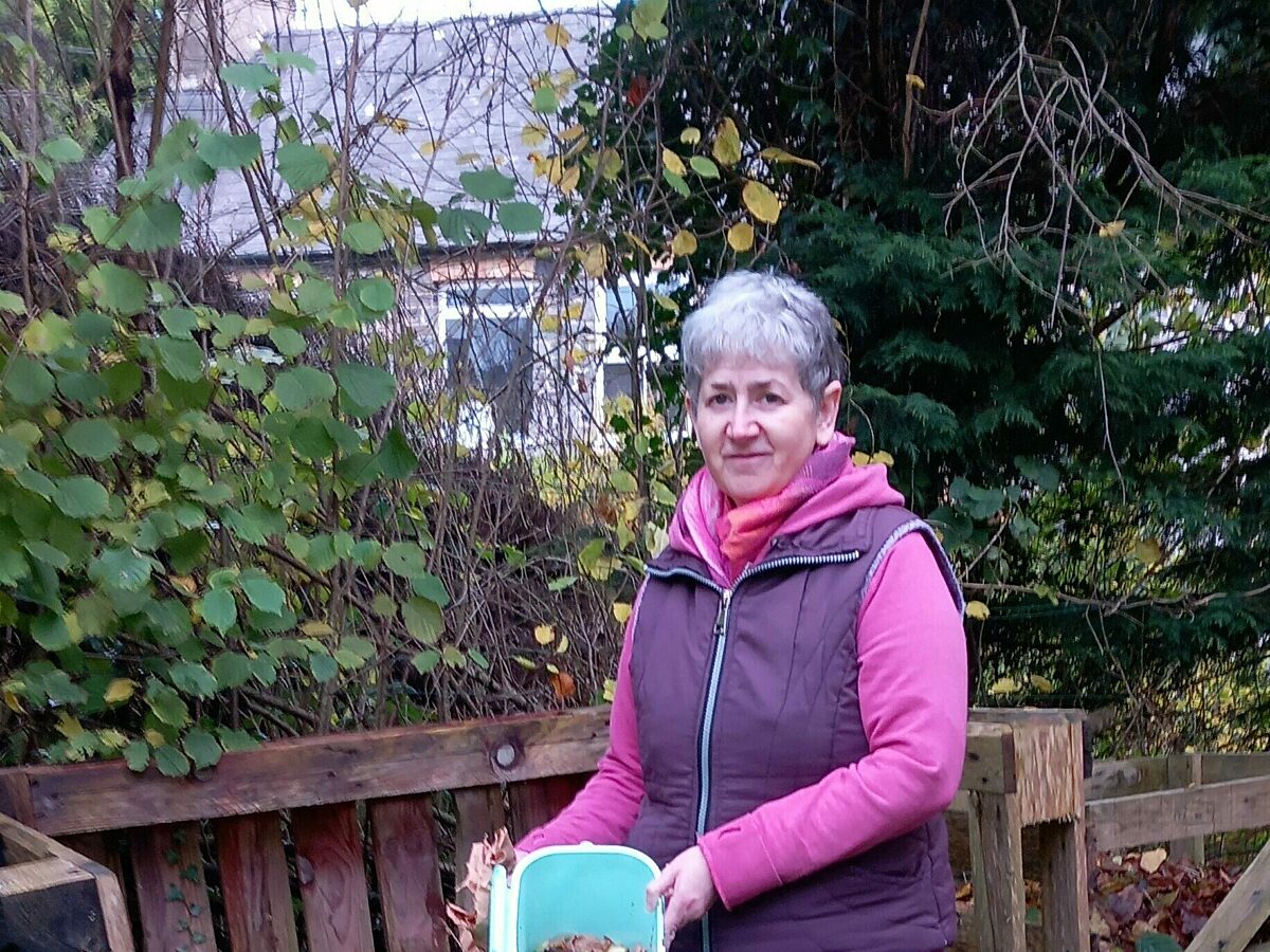 Viv standing in back garden with compost caddy